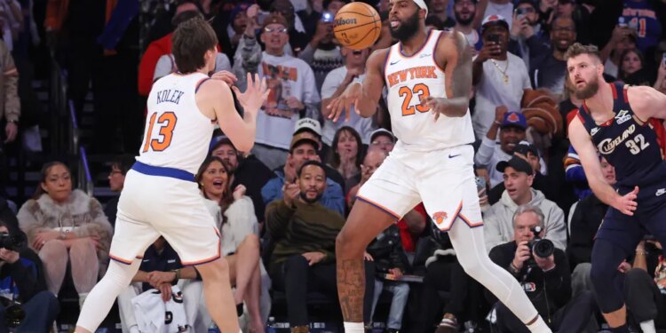 Mitchell Robinson #23 passes the ball to New York Knicks guard Tyler Kolek #13 during the fourth quarter.
