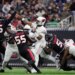 Arizona Cardinals quarterback Jacoby Brissett passes as Houston Texans defensive ends Denico Autry, Danielle Hunter (55), and Will Anderson Jr. (51) pressure him.