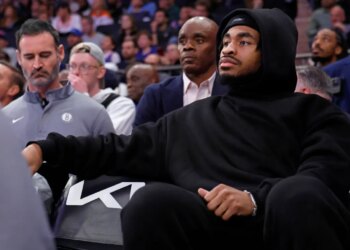 Cam Thomas #24 of the Brooklyn Nets on the bench in plain clothes.