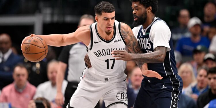 Brooklyn Nets forward Michael Porter Jr. (17) looks to move the ball past Dallas Mavericks forward Naji Marshall (13) during the game between the Mavericks and the Nets at the American Airlines Center.