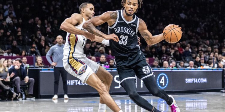 Nic Claxton #33 of the Brooklyn Nets drives pass Bryce McGowens #11 of the New Orleans Pelicans during the second half at Barclays Center, Saturday, Dec. 6, 2025, in Brooklyn, NY.