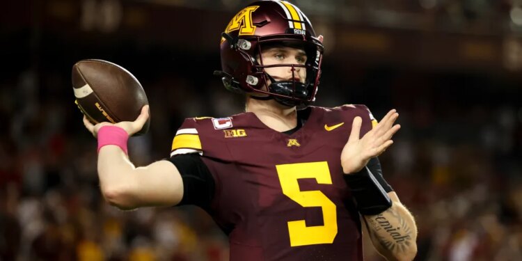 Minnesota quarterback Drake Lindsey (5) warms up on the sideline during the first half of an NCAA college football game against Nebraska, Friday, Oct. 17, 2025, in Minneapolis.