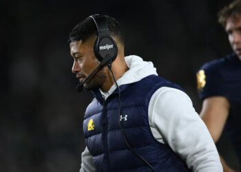 Notre Dame head coach Marcus Freeman, left, looks on during the fourth quarter of an NCAA football game against Syracuse, Saturday, Nov. 22, 2025, in South Bend, Ind.