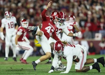 Alabama defensive lineman Tim Keenan III (96) blocks a punt by Oklahoma kicker Grayson Miller (43) during a football game.