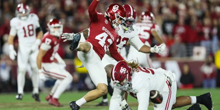 Alabama defensive lineman Tim Keenan III (96) blocks a punt by Oklahoma kicker Grayson Miller (43) during a football game.