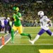 Oregon Ducks quarterback Dante Moore (5) rushing for a touchdown as James Madison Dukes safety Tyler Brown (13) defends.