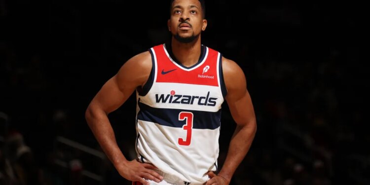A Washington Wizards player wearing a number 3 jersey, looking up.