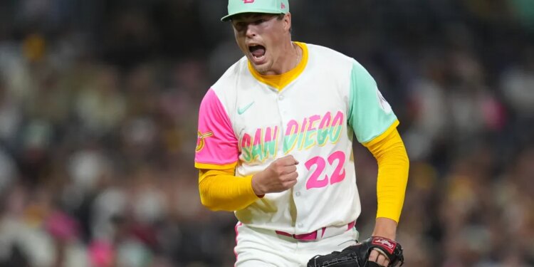 A San Diego Padres pitcher in a colorful uniform celebrates on the mound.