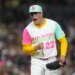 A San Diego Padres pitcher in a colorful uniform celebrates on the mound.