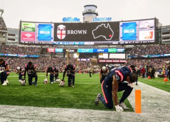 New England Patriots wide receiver Stefon Diggs (8) and teammates on the field during a tribute for the victim of the shooting at Brown University in Providence RI before the start of the game against the Buffalo Bills at Gillette Stadium.