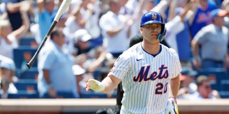 Pete Alonso #20 of the New York Mets flips his bat after he hits a three-run home run during the third inning.
