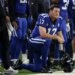 Indianapolis Colts quarterback Philip Rivers (17) on one knee looking on with his helmet in hand.