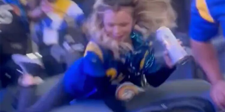 A viral video shows a blonde woman, who's sporting a Rams' Aaron Donald jersey, trying to kick someone before she falls forward and tumbles down a few rows of seats at SoFi Stadium in Inglewood, Calif. on December 14, 2024.