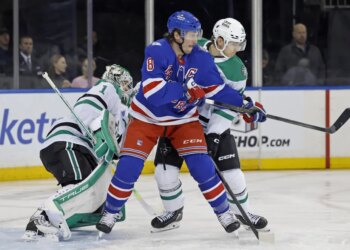 J.T. Miller battles for position with Ilya Lyubushkin during the Rangers' OT win over the Stars on Dec. 2, 2025.
