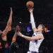 Utah Jazz forward Lauri Markkanen shoots the ball over New York Knicks center Karl-Anthony Towns.