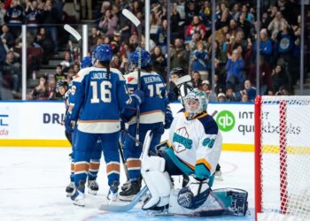 The Vancouver Goldeneyes' Sophie Jaques and Gabby Rosenthal celebrate after a goal by Abby Boreen (obscured) past Sirens goaltender Kayle Osborne during the third period of Saturday's game in Vancouver, British Columbia.