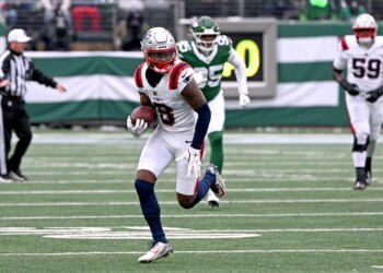 Patriots wide receiver Stefon Diggs (8) runs with the ball on the field.