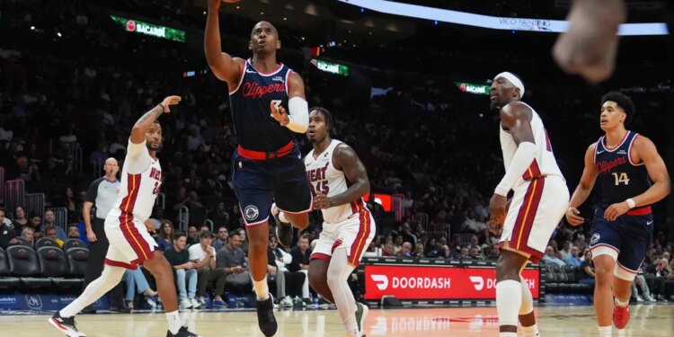 Chris Paul going for a basket during an NBA game against the Miami Heat.