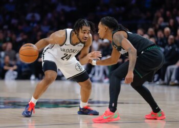 Brooklyn Nets guard Cam Thomas (24) handles the ball while Minnesota Timberwolves guard Rob Dillingham defends.