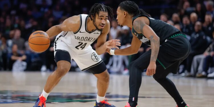 Brooklyn Nets guard Cam Thomas (24) handles the ball while Minnesota Timberwolves guard Rob Dillingham defends.
