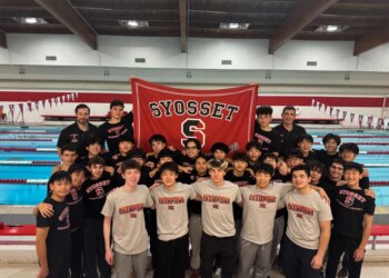 The Syosset boys swim team with their coaches and a banner for Syosset Swimming & Diving.