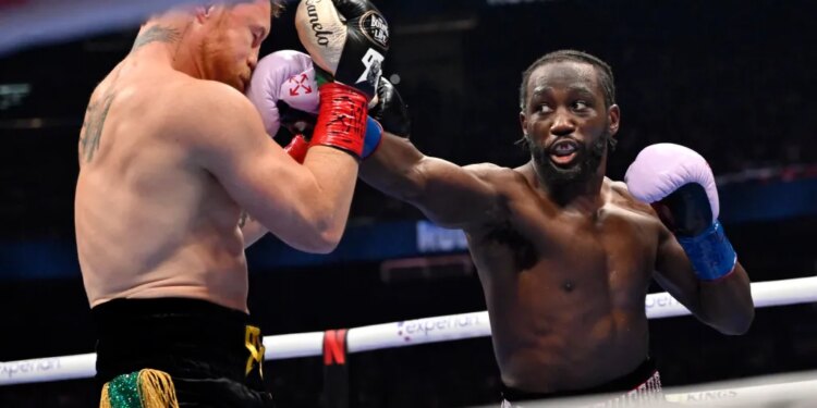 Terence Crawford, right, connects with Canelo Alvarez during a super middleweight championship boxing match in Las Vegas, Sept. 13, 2025.