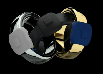 Three different colors of a ring, with a button on it, on a black background.