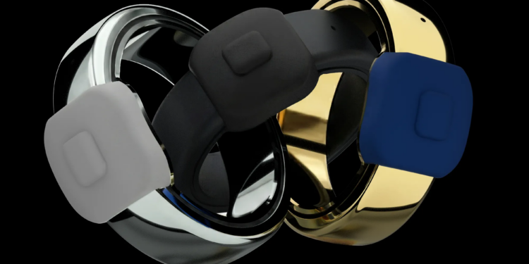 Three different colors of a ring, with a button on it, on a black background.