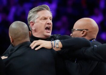 Staff restrains Minnesota Timberwolves head coach Chris Finch after a referee ejected him for chasing him down on a call for the Oklahoma City Thunder in the first quarter at Target Center.