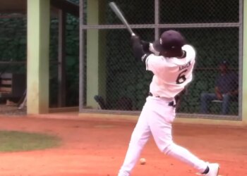 Baseball player Wandy Asigen hitting a baseball.