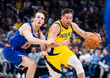 Indiana Pacers guard T.J. McConnell dribbles the ball while New York Knicks guard Tyler Kolek defends.