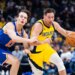 Indiana Pacers guard T.J. McConnell dribbles the ball while New York Knicks guard Tyler Kolek defends.