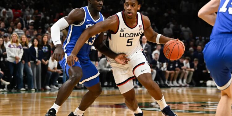 UConn Huskies forward Tarris Reed Jr. (5) drives to the basket against BYU Cougars center Keba Keita (13).