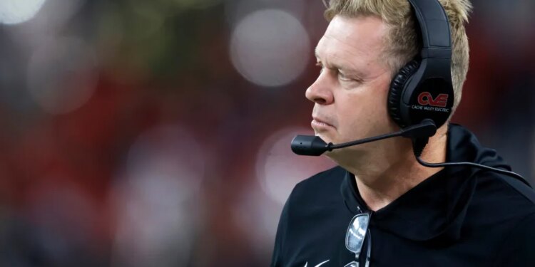 Utah State head football coach Bronco Mendenhall watching from the sideline.