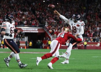 Caleb Williams of the Chicago Bears passes while being pressured by Yetur Gross-Matos of the San Francisco 49ers.
