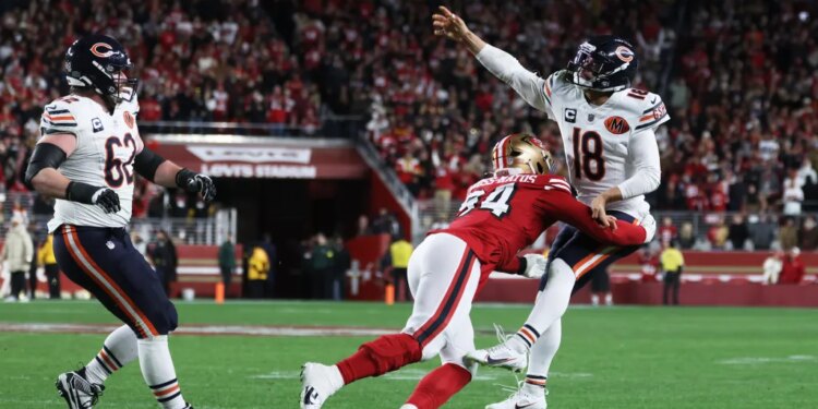 Caleb Williams of the Chicago Bears passes while being pressured by Yetur Gross-Matos of the San Francisco 49ers.