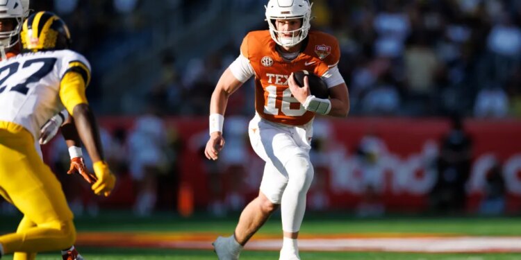 Texas Longhorns quarterback Arch Manning (16) runs with the ball against the Michigan Wolverines.
