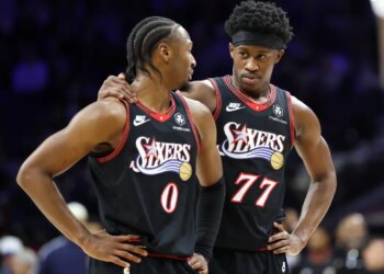 Philadelphia 76ers guard Tyrese Maxey (0) and guard Vj Edgecombe (77) talk during a break in the game.