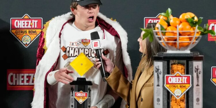 Texas quarterback Arch Manning makes remarks to fans after winning the MVP award in the Citrus Bowl NCAA college football game against Michigan, Wednesday, Dec. 31, 2025, in Orlando, Fla.