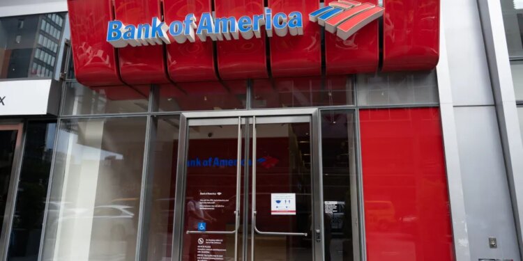 Exterior of a Bank of America branch in New York City with a prominent red sign and logo.