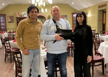 M. Night Shyamalan with Ahmed al-Ahmed and a woman in a restaurant.