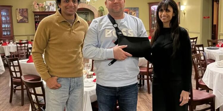 M. Night Shyamalan with Ahmed al-Ahmed and a woman in a restaurant.