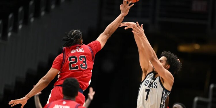 Bryce Hopkins blocks Isaiah Abraham's shot during the first half of St. John's 95-83 win over Georgetown on Dec. 31, 2025 in Washington.