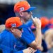 New York Mets manager Carlos Mendoza and pitching coach Jeremy Hefner in orange and blue caps.