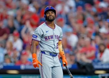 Cedric Mullins in a New York Mets uniform, batting gloves and helmet, holding a bat after striking out.