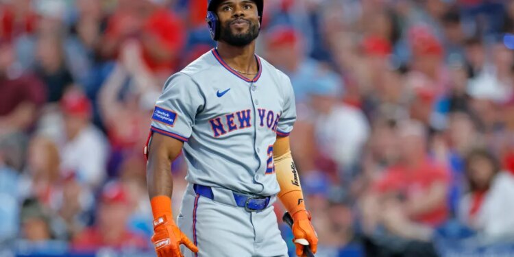 Cedric Mullins in a New York Mets uniform, batting gloves and helmet, holding a bat after striking out.