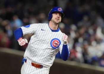 Dodgers Tucker in a baseball uniform with a helmet running.