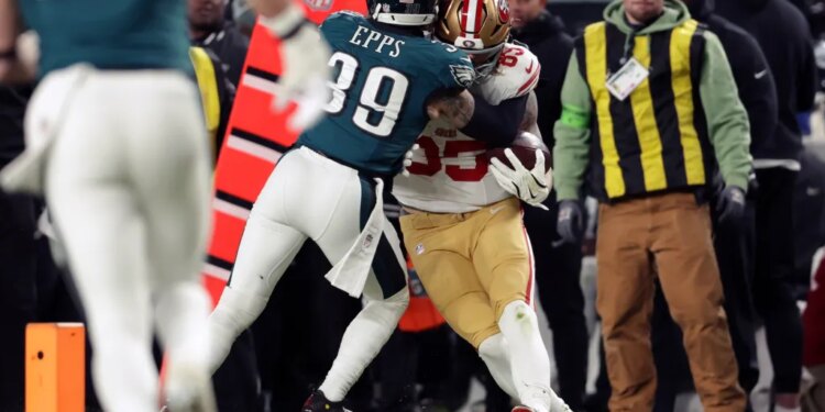 Philadelphia Eagles' Marcus Epps tackling San Francisco 49ers' George Kittle during an NFL wild-card playoff football game.