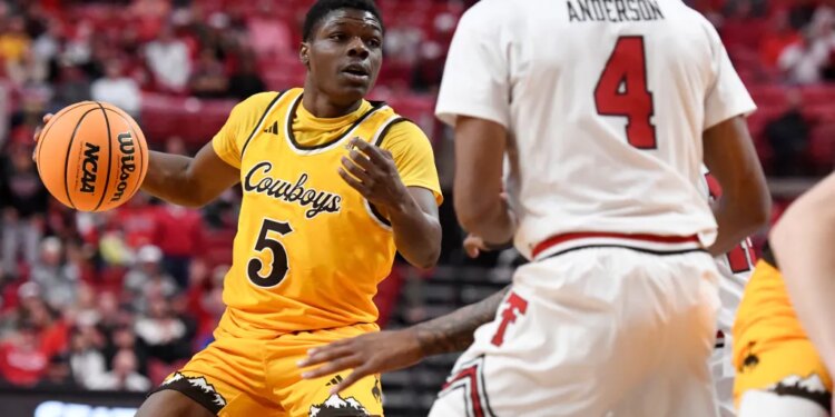 Wyoming guard Leland Walker (5) dribbles the ball during the second half in an NCAA college basketball game against Texas Tech.
