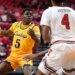 Wyoming guard Leland Walker (5) dribbles the ball during the second half in an NCAA college basketball game against Texas Tech.